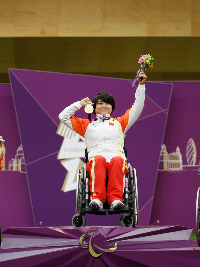 A picture of women on a podium with medals around their neck