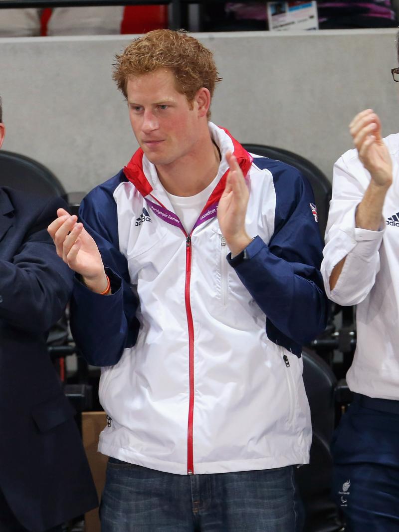 A picture of 3 men standing and applauding