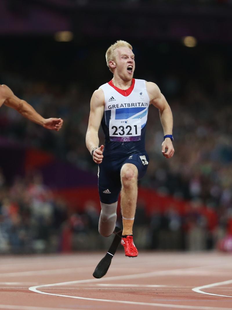 A picture of 3 men crossing the finish line during an athletics race