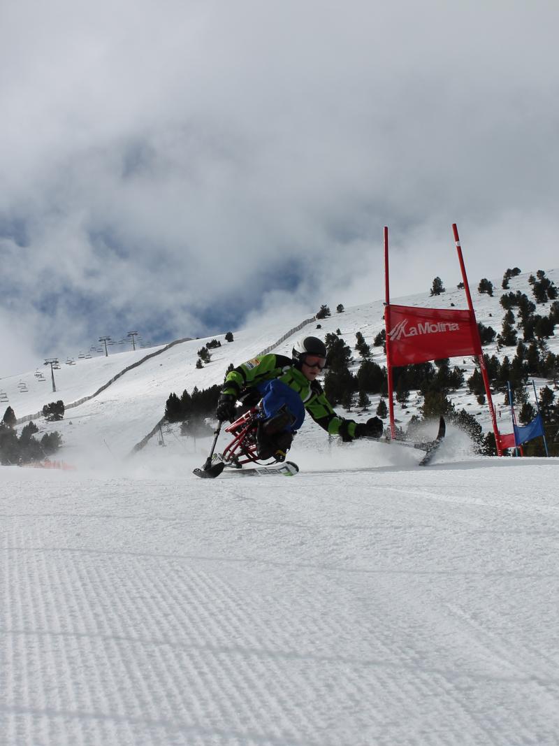 A picture of people sitting in sledges and ready to ski