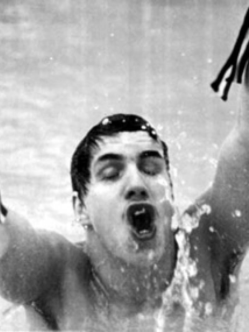 A picture of man in a pool celebrating his victory
