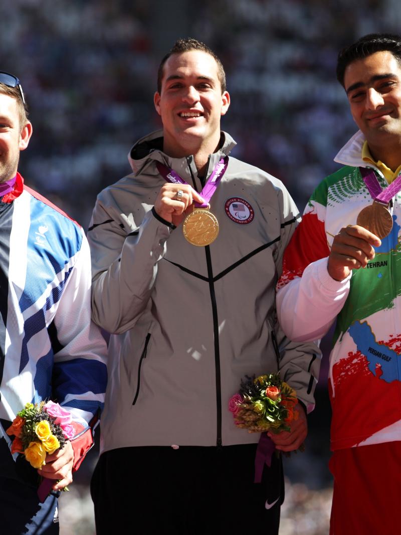 Dan Greaves, Jeremy Campbell and Farzad Sepahvand pose on the podium during the medal ceremony for the Men's Discus Throw F44 final at the London 2012 Paralympic Games