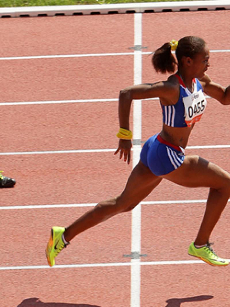 Mandy Francois-Elie sprinting on a tartan track leading the field.