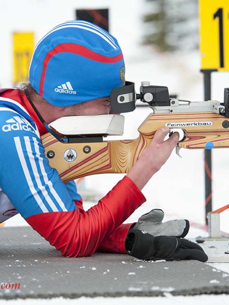 Azat Karachurin lies to shoot a gun in hte short course biathlon event