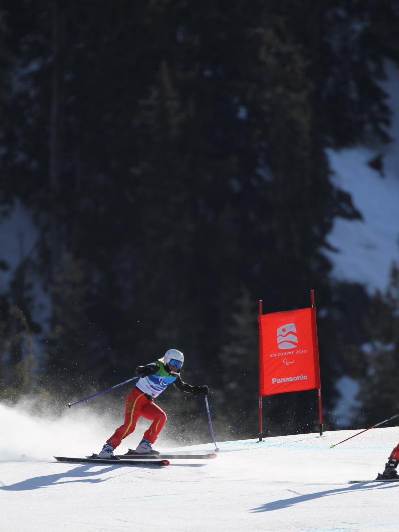 Natasha de Troyer of Belgium and guide Diego van de Voorde compete in the Women's Visually Impaired Downhill during Day 7 of the 2010 Vancouver Winter Paralympics