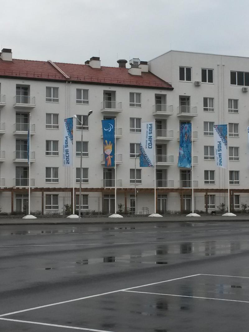 The coastal cluster Paralympic village wit flags in front of the buildings