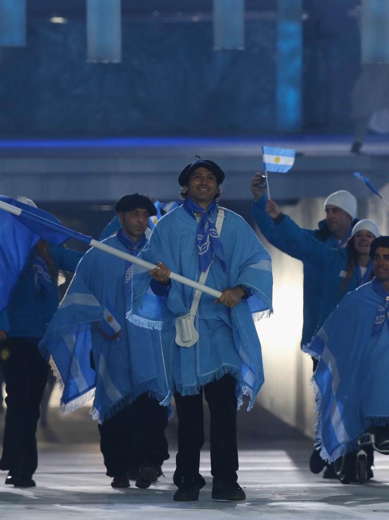 Argentina enter the arena lead by flag bearer Pablo Javier Robledo during the Opening Ceremony of the Sochi 2014 Paralympic Winter Games