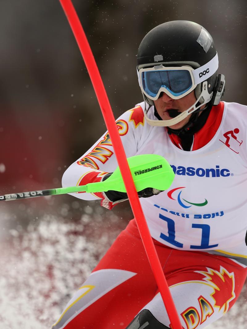 Mac Marcoux in a close-up focussing on the slalom pole in front of him