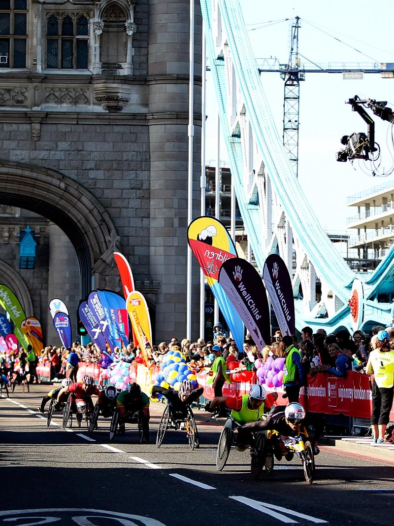 Men's wheelchair racers cross Tower Bridge in the 2014 Virgin Money London Marathon