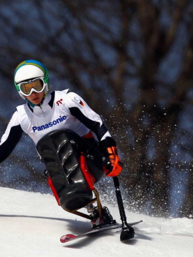 Athlete practicing alpine skiing in a sit-ski.