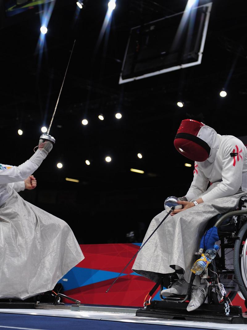 Athletes practicing wheelchair fencing.