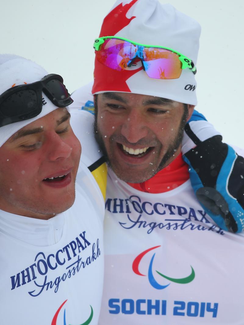 Two athletes embrace each other for a close-up photo.