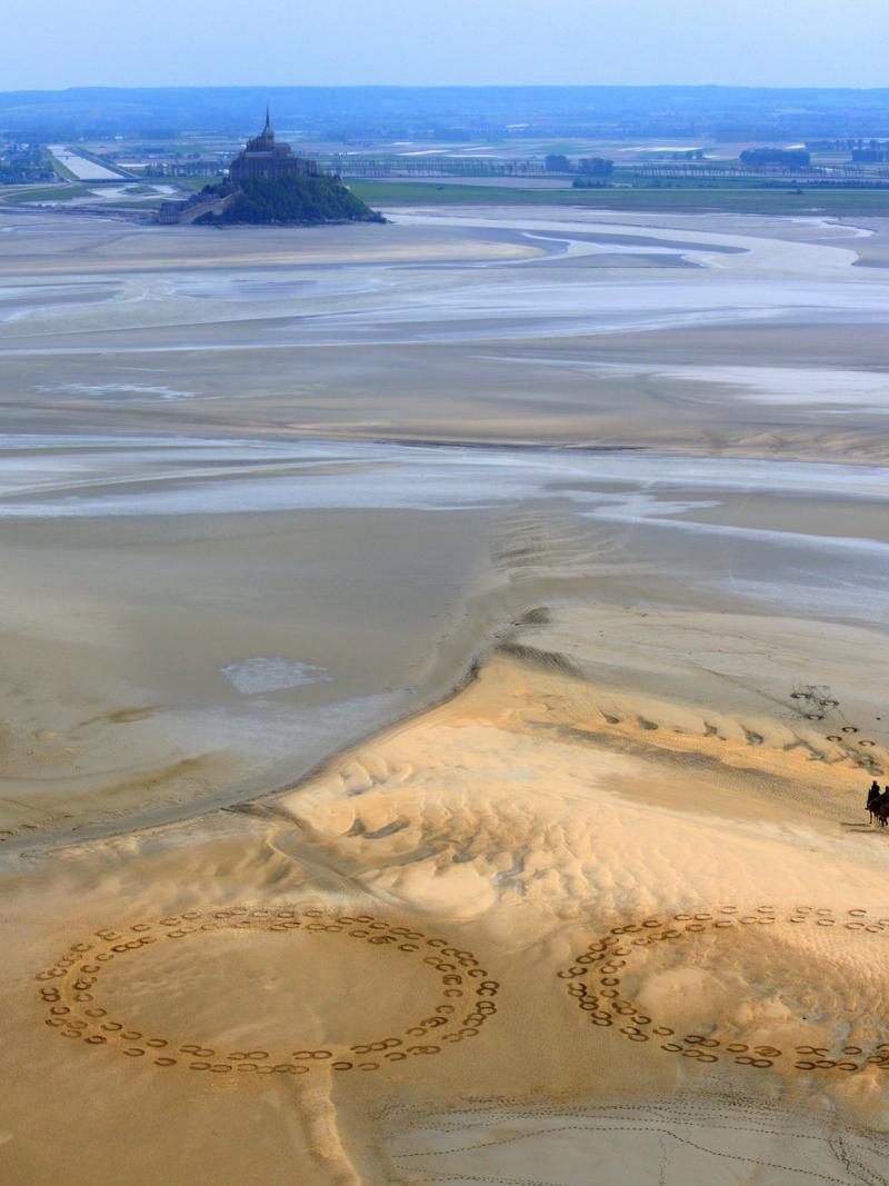 Giant 2.3m by 2.5m horse hoof prints created in the Bay of Mont-Saint-Michel by French artist and sand sculptor Christophe Dumont mark 100 days to the start of the Alltech FEI World Equestrian Games.