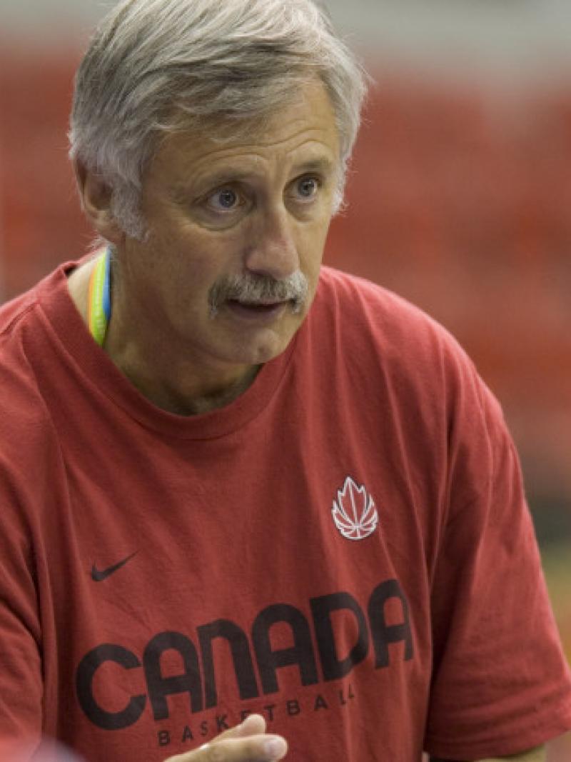A picture of a basketball coach giving his advices