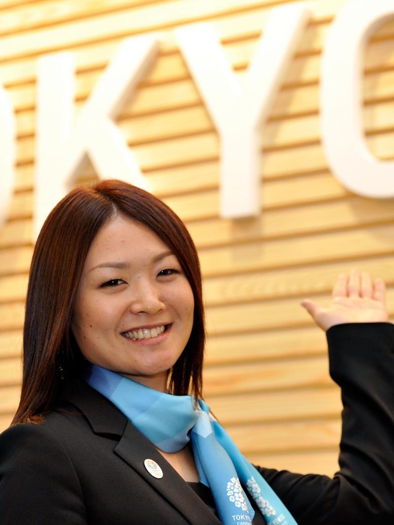 A woman speaks at a podium.