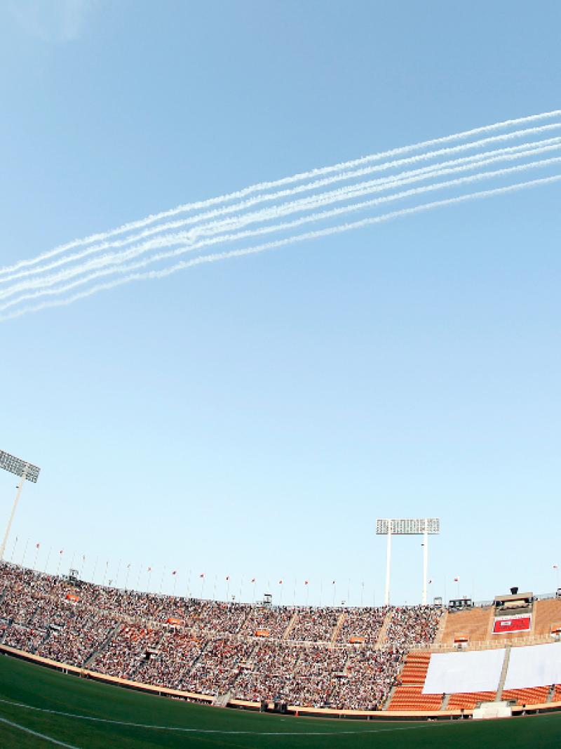 Japan Air Self-Defense Force aerobatic demonstration team ‘Blue Impulse’ in action over the National Stadium and 40,000 fans.