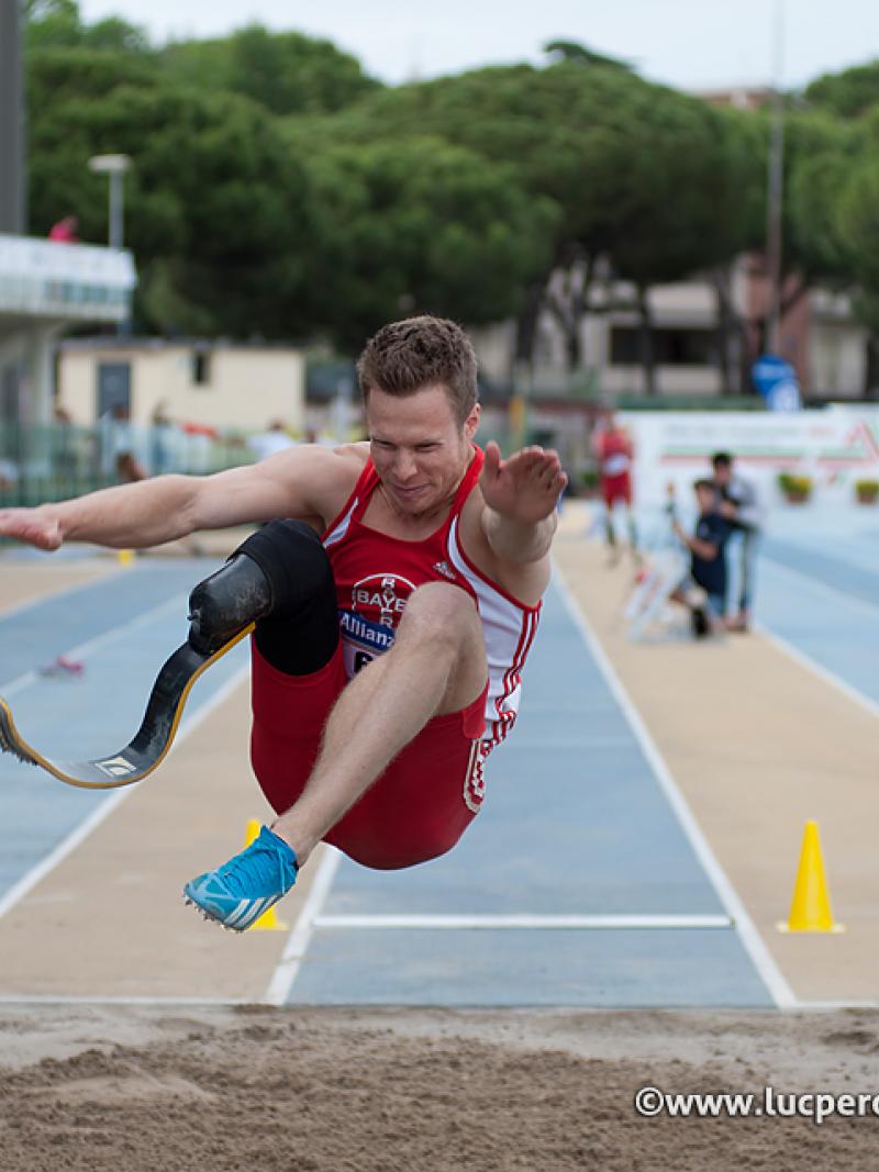 Markus Rehm, single leg amputee extends his legs over the long jump pit