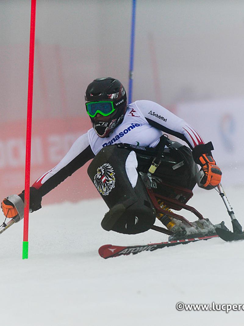 Woman on sit ski on the slopes