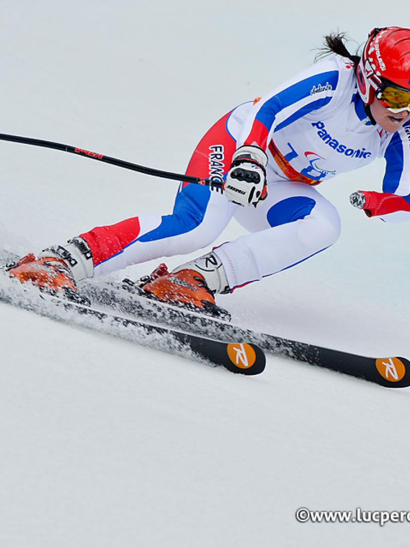 France's standing skier Marie Bochet skiing around a gate.