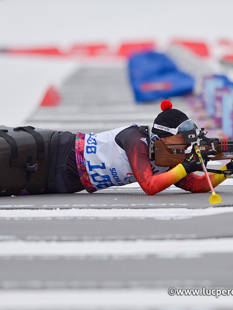 Women in sit ski lies in the shooting range and targets