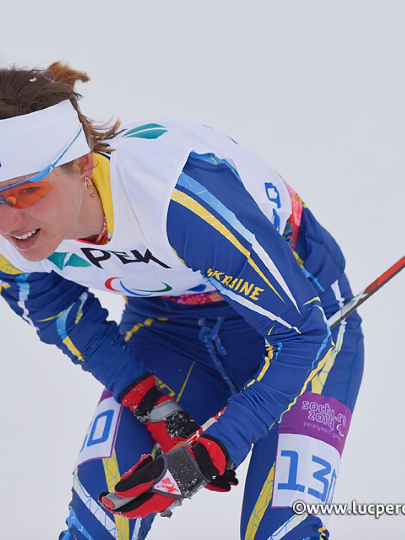 Female skier looks exhausted on the snow.