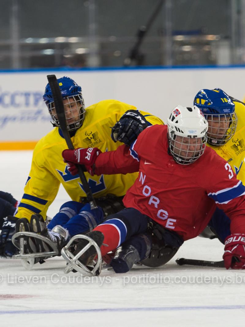 NOR vs. SWE Norweigen player Rolf Einar Pedersen defends puck against two Sweedish players