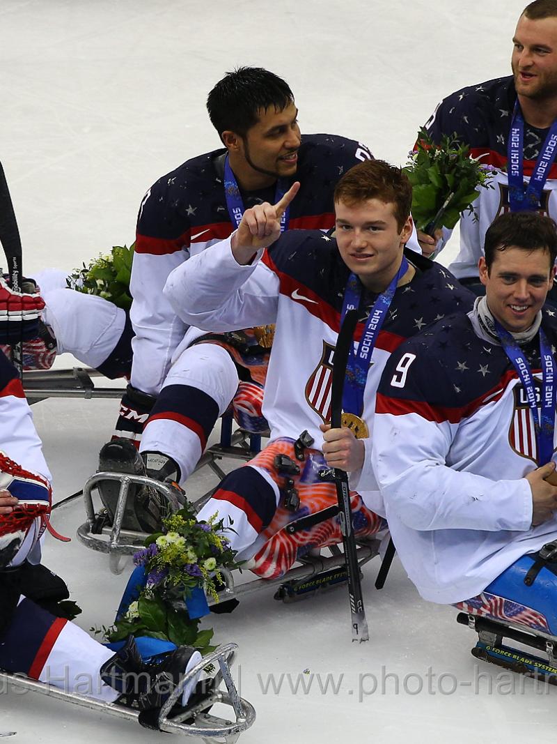 US players in their sledges on the ice after winning against Russia.