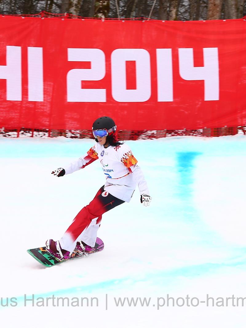 Michelle Salt, Canada flys by a gate in the first ever Women's Para Snowboarding Cross in the Winter Paralympic Games
