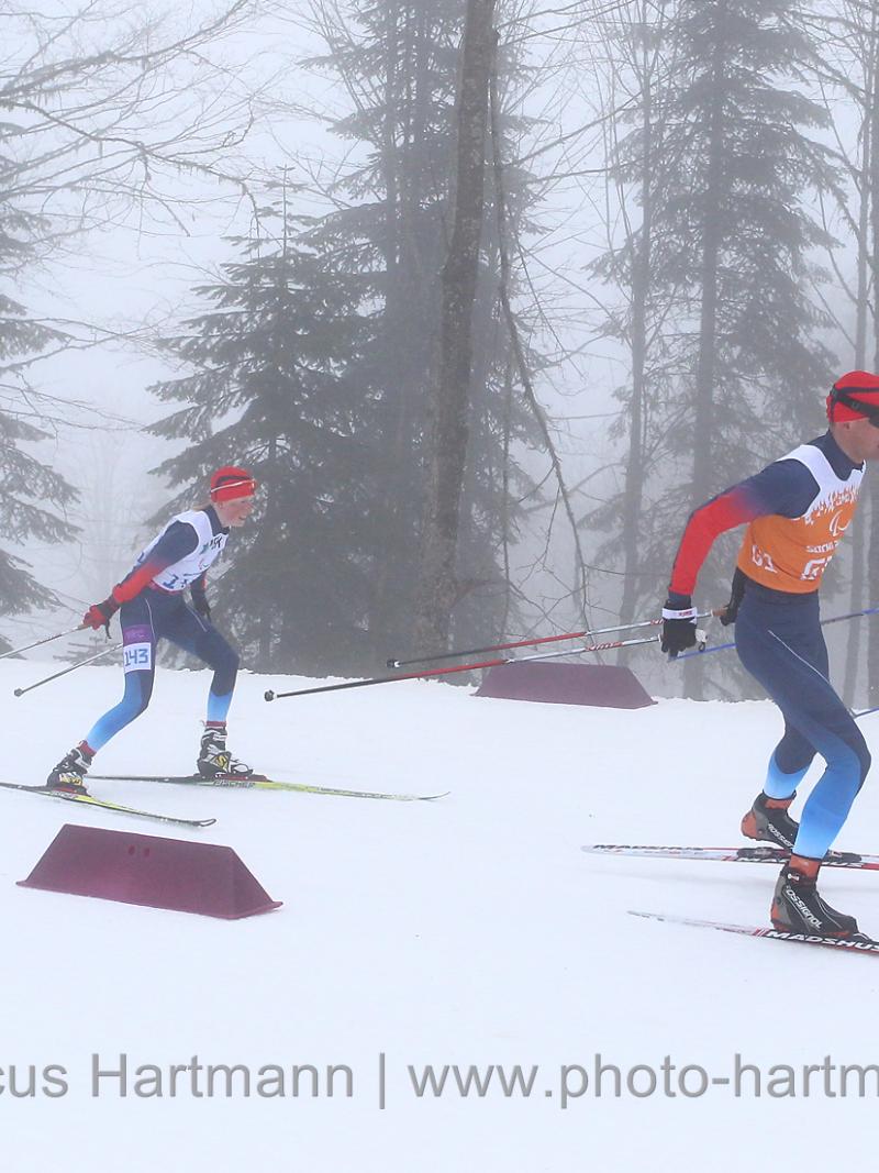 Four people do cross-country skiing on slopes