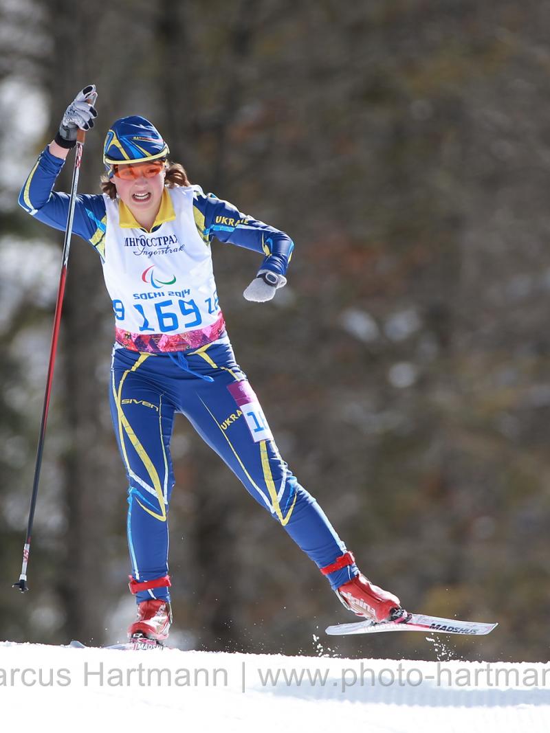 Women on cross country ski in action on the track