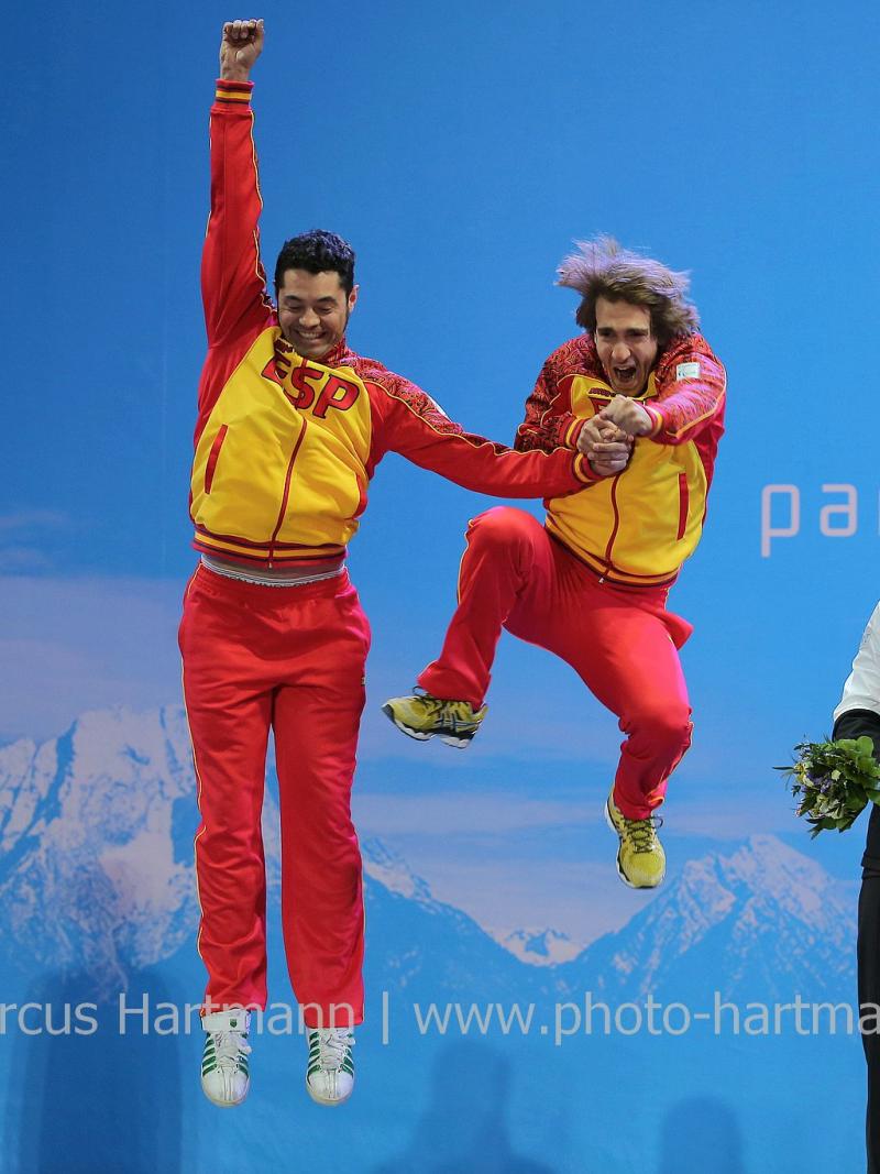 Two men jumping on the podium