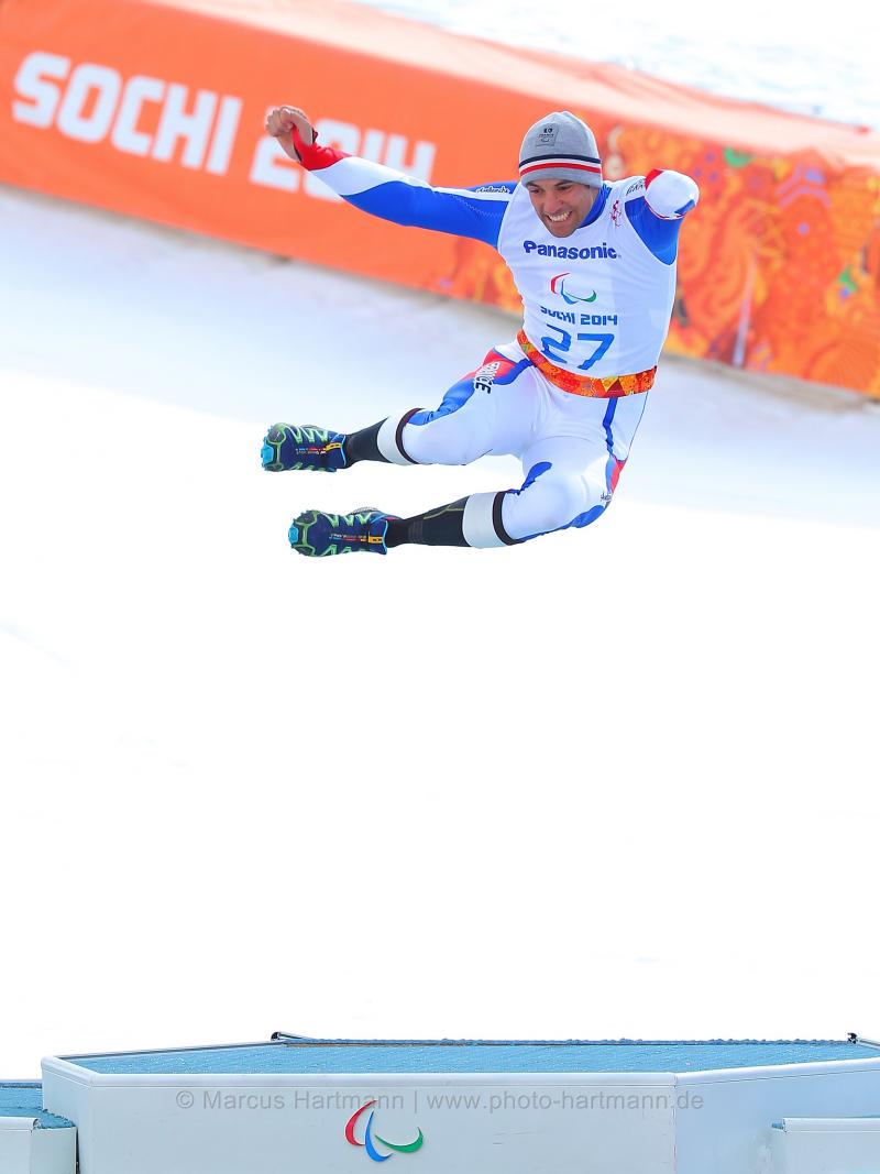 Man jumping in the air on a podium