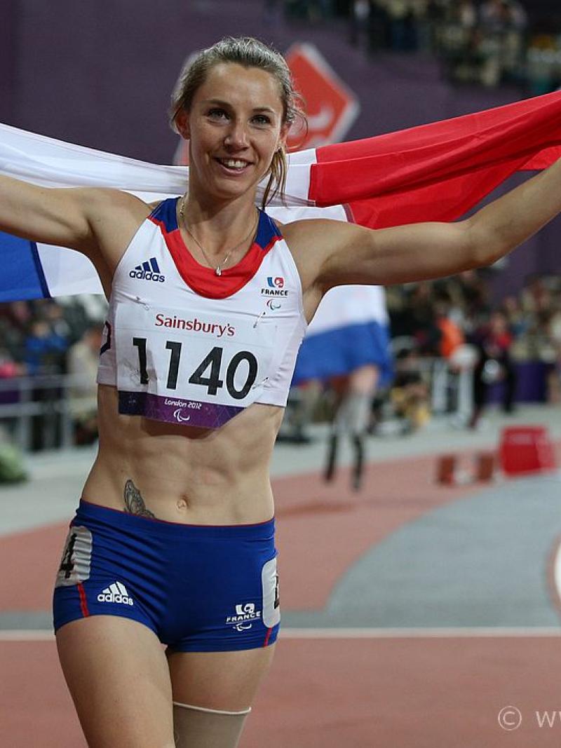 Woman with French flag celebrating in a stadium
