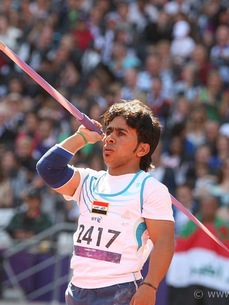 Man holds javelin and prepares to throw