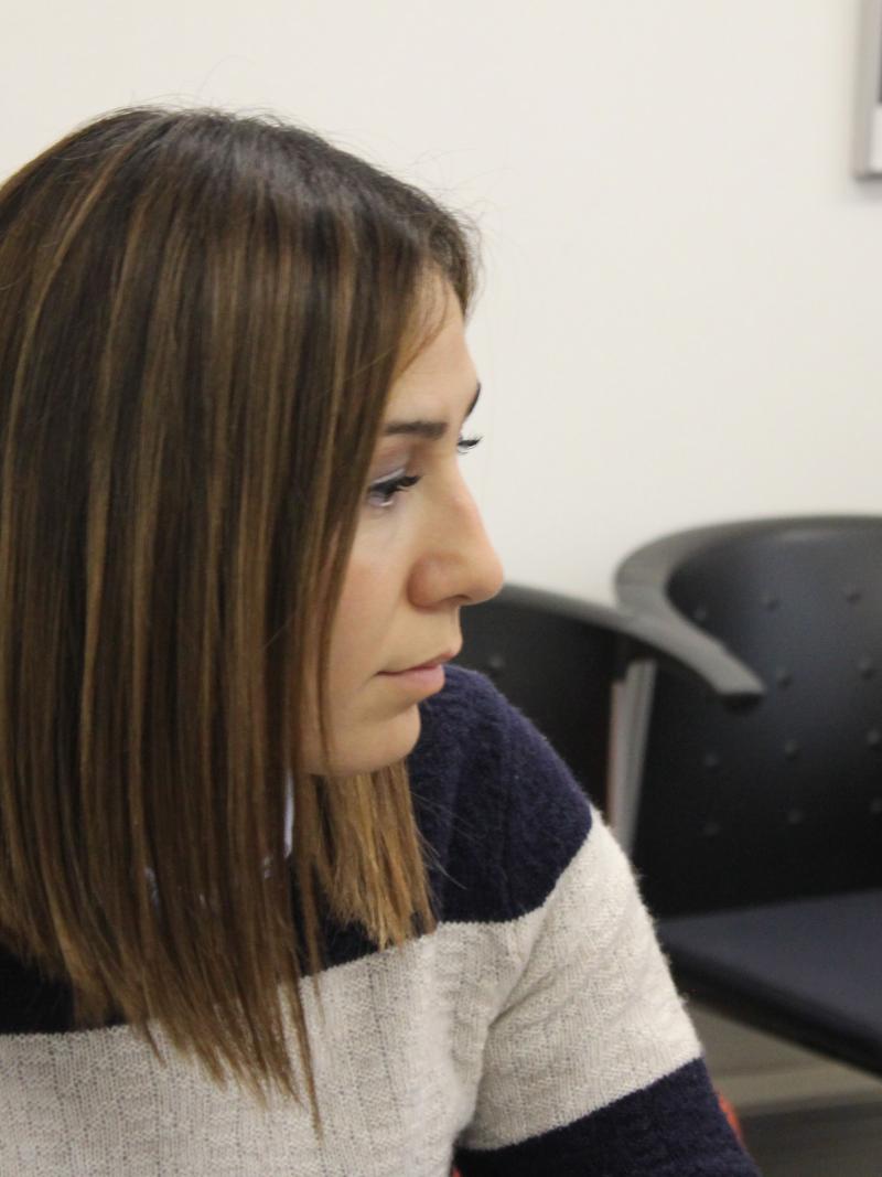 Gizem Girismen loioks to one side during a meeting