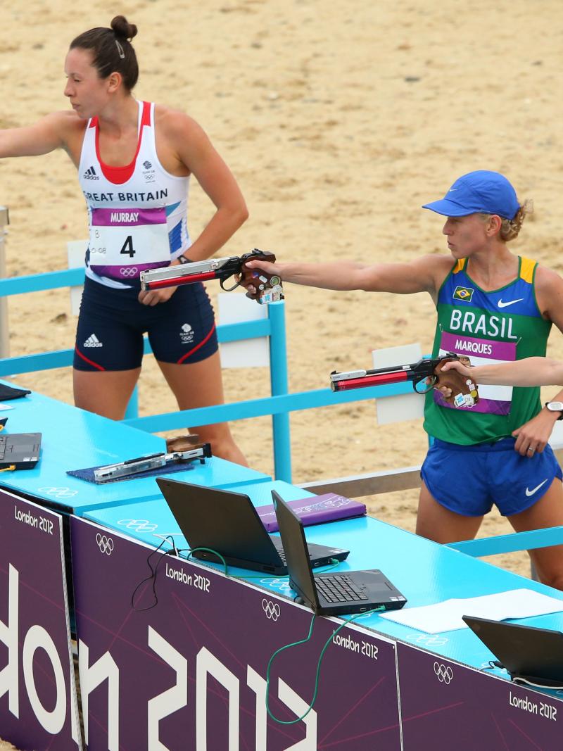 Women in a shooting range with the branding "London 2012"
