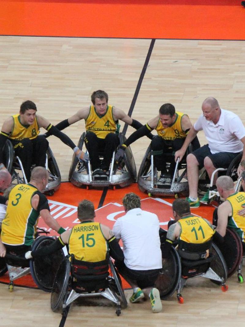 men in wheelchairs make a circle