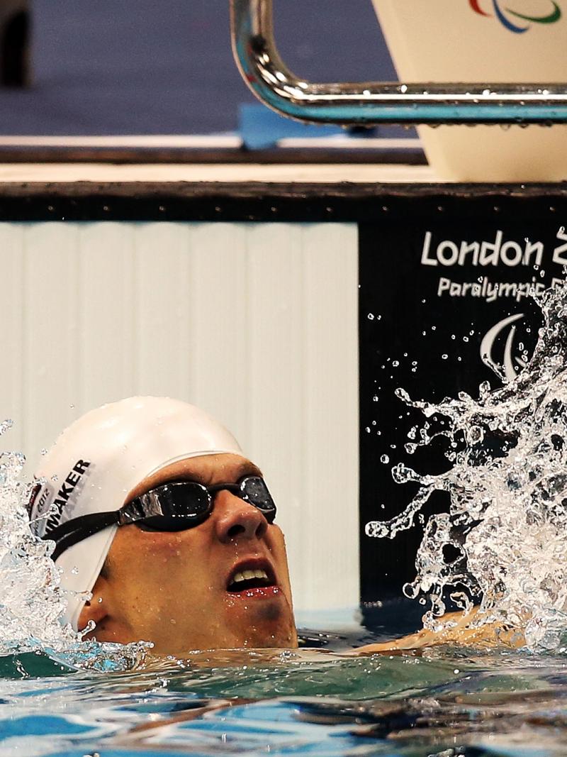 A swimmer clenches his fists in delight after winning gold at London 2012.