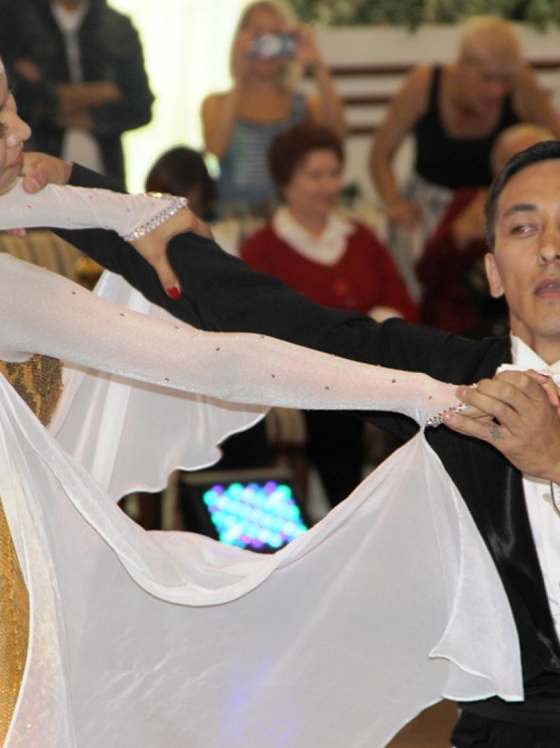 Two dancers, one in wheelchair, one standing pose