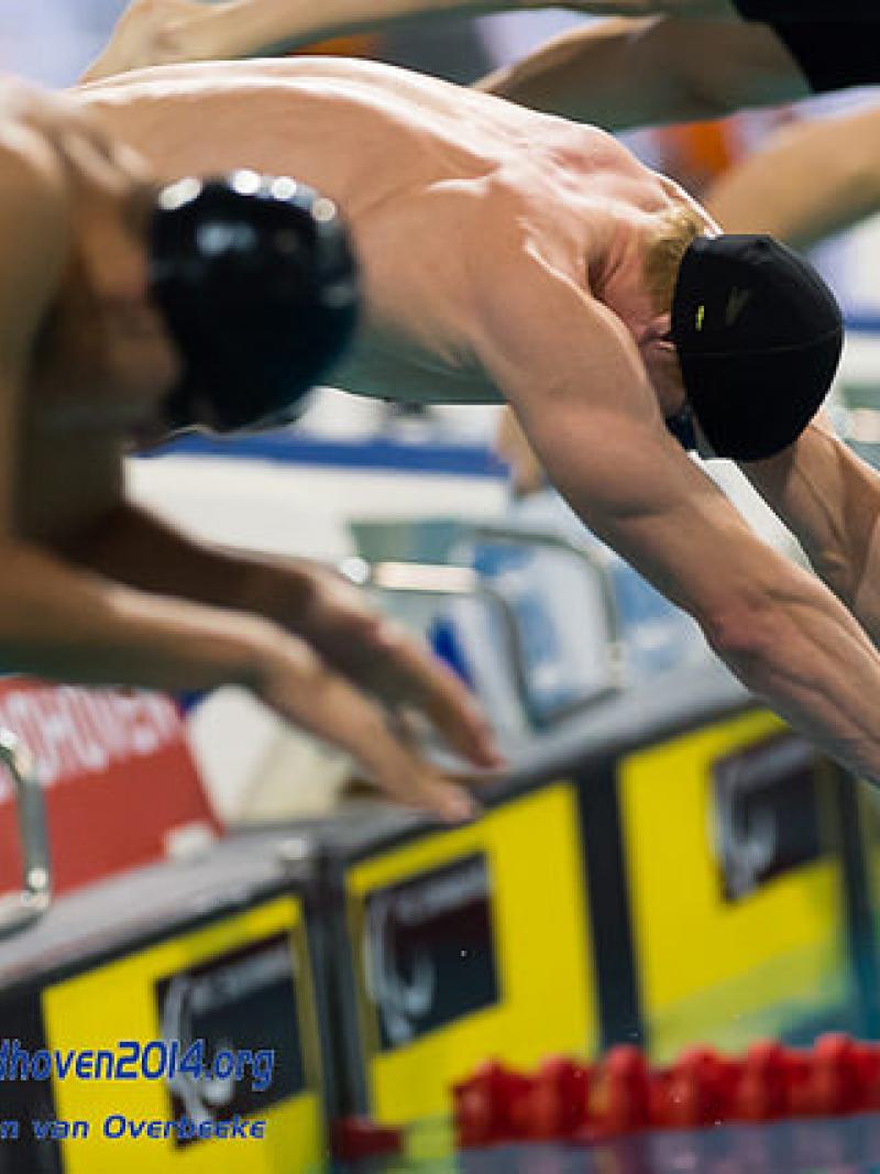 Male swimmers start a race at the 2014 IPC Swimming European Championships