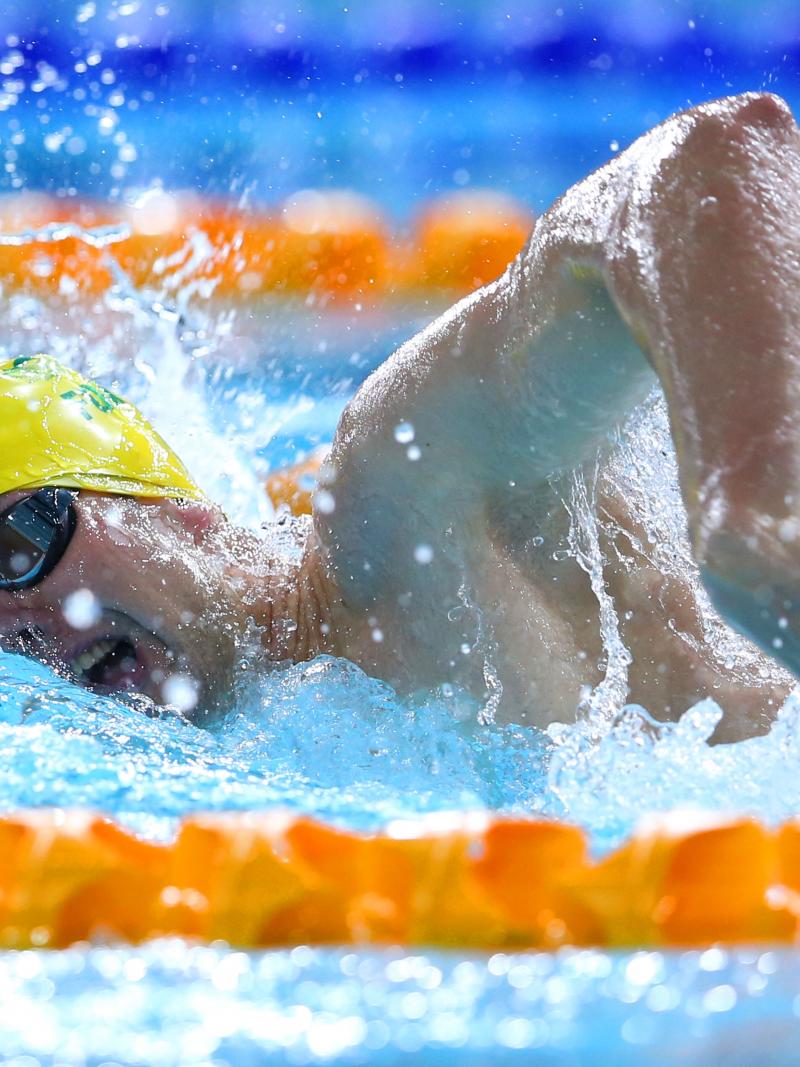 Australia's Daniel Fox in a yellow swim cap swimming freestyle