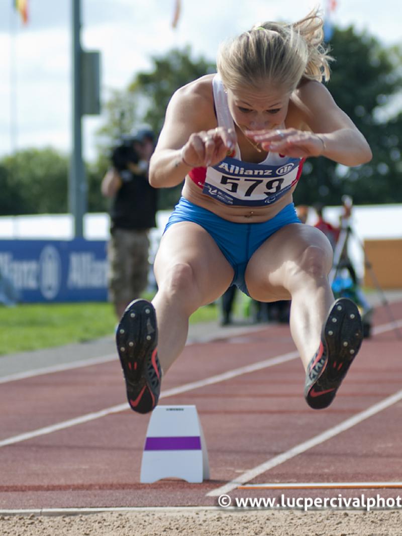 Women doing long jump shortly before the landing