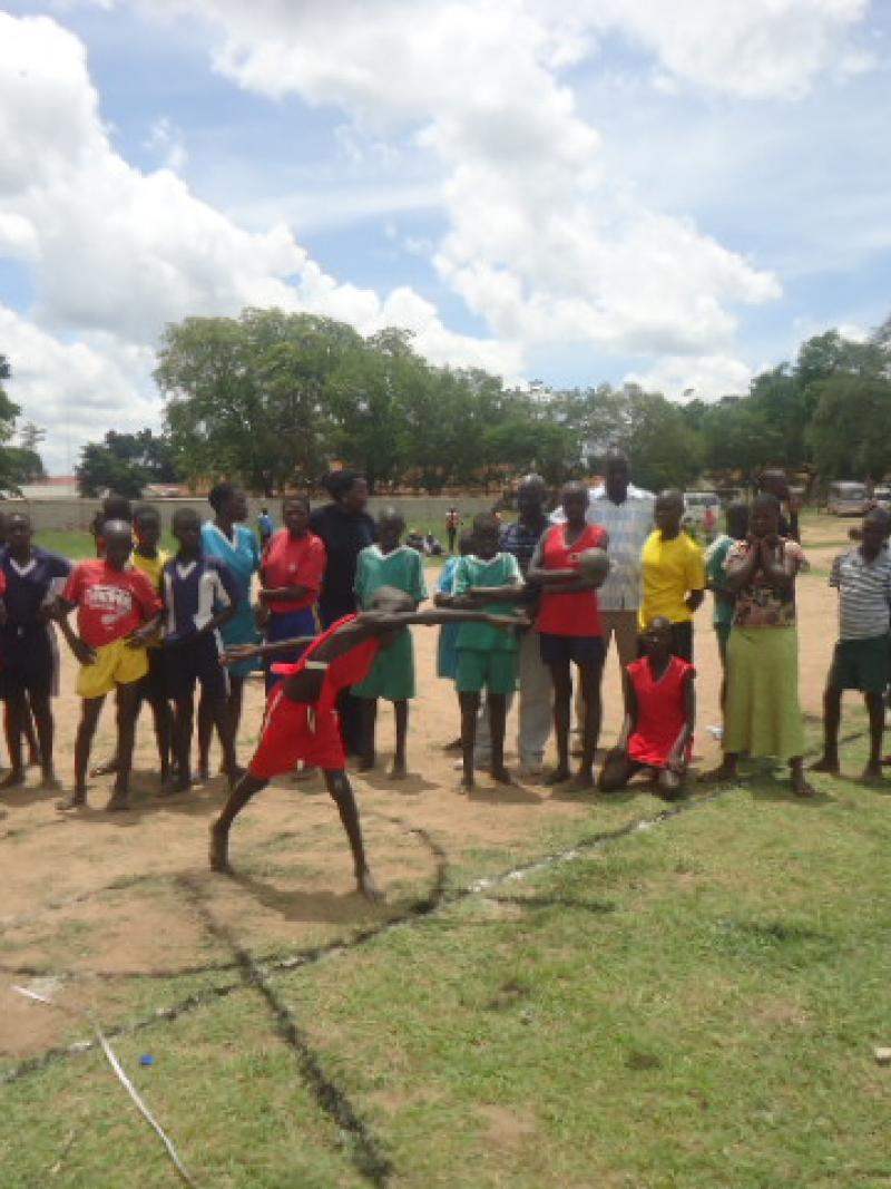A young Ugandan tries out shot-put