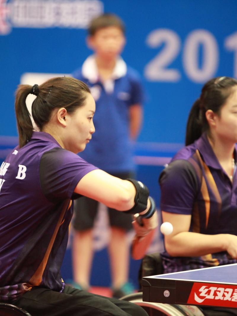 two female Chinese para table tennis players playing doubles