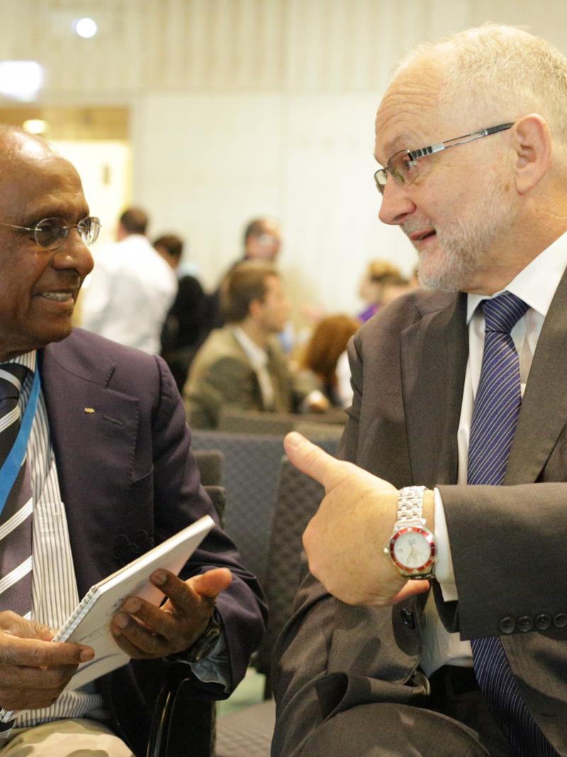 Sam Ramsamy and Sir Philip Craven talking and smiling 