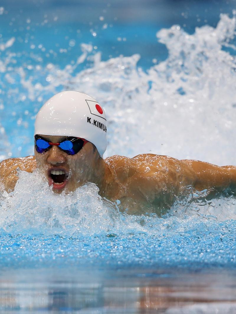 Swimmer in butterfly style in a pool with a simming cap