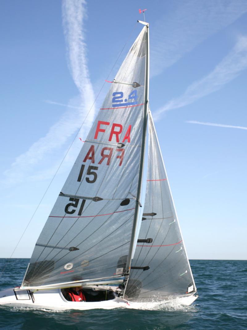 Man inside sailing boat with FRA and 15 written on the sail