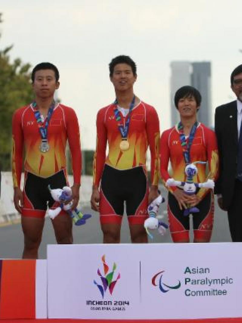 Three Chinese athletes standing on the podium