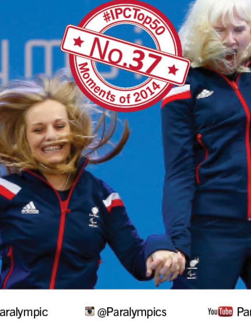 Two women make a jump of joy on a podium