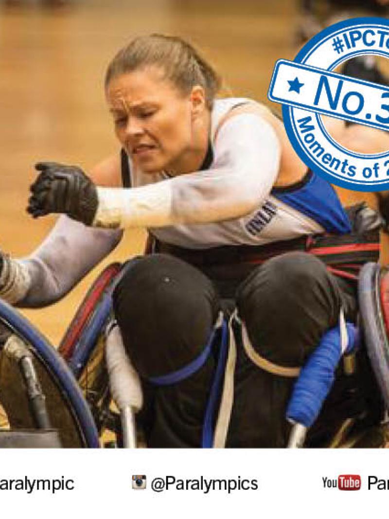 Picture of a female wheelchair rugby player fighting for the ball.